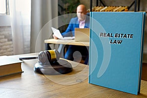Jurist holds REAL ESTATE LAW book. Real estate lawÂ encompasses the purchase and sale of real property, meaning land and any